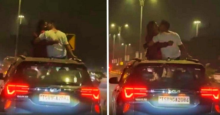couple kissing on top of kia seltos roof