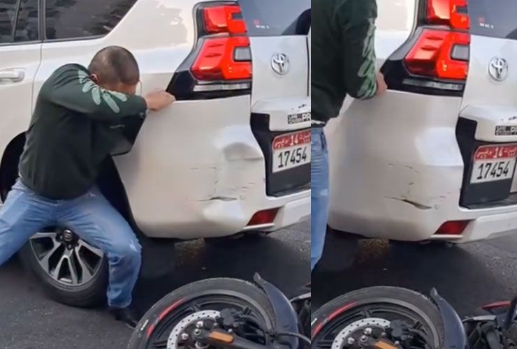 man fixes dents with bare hands