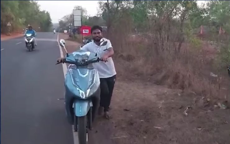 man pushes e-scooter for 20 km