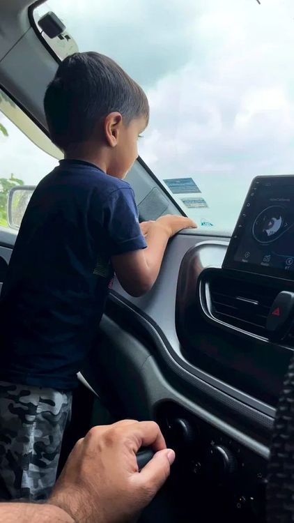 kid standing inside car