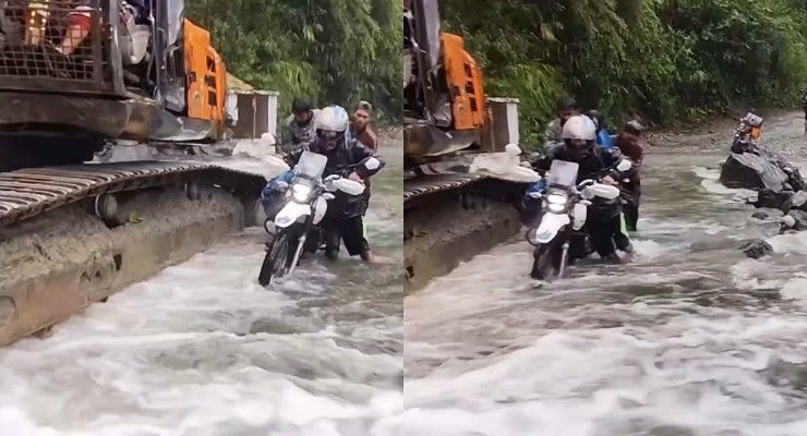 poclain machine helping bikers cross stream