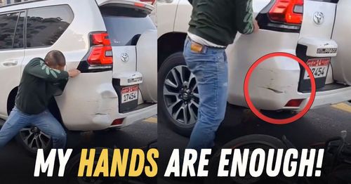 man fixes dents with bare hands