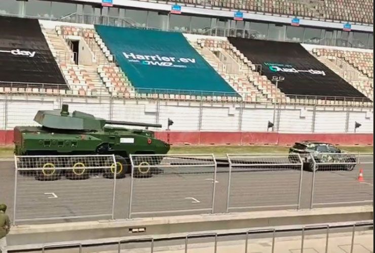 tata harrier ev pulling a military tank